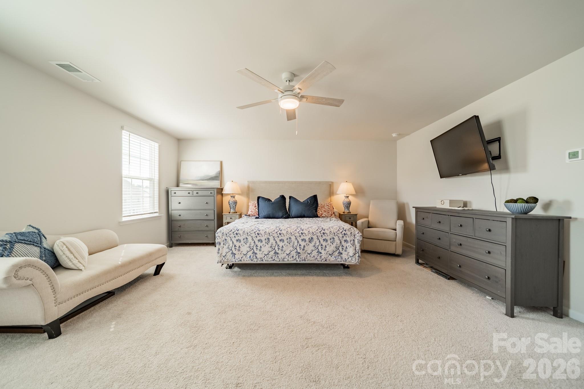 5542 Soft Shell Drive Lancaster, SC 29720 - Photo 23 of 43 a bedroom with a bed and a flat screen television