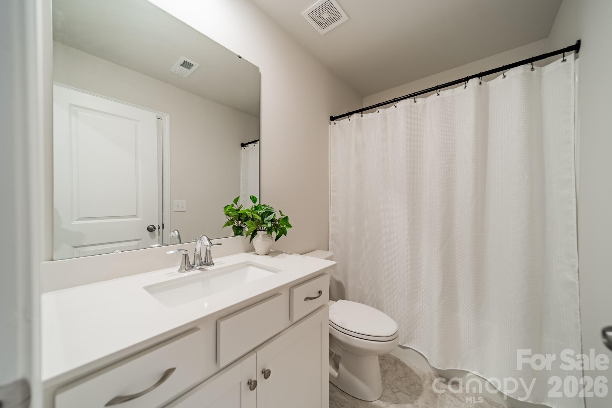 5542 Soft Shell Drive Lancaster, SC 29720 - Photo 30 of 43 a bathroom with a sink a toilet and shower curtain