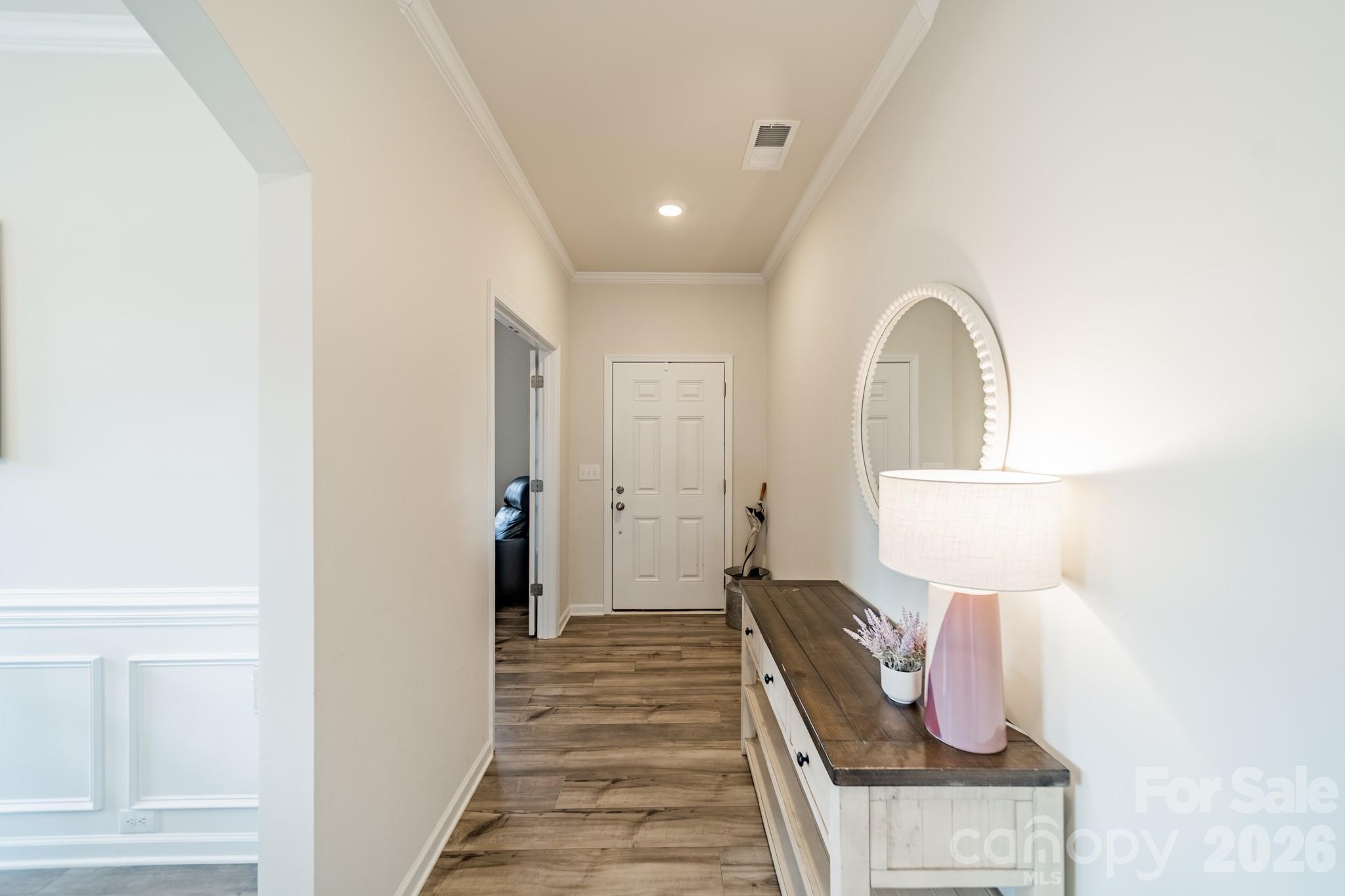 5542 Soft Shell Drive Lancaster, SC 29720 - Photo 4 of 43 a view of a hallway with entryway wooden floor and front door