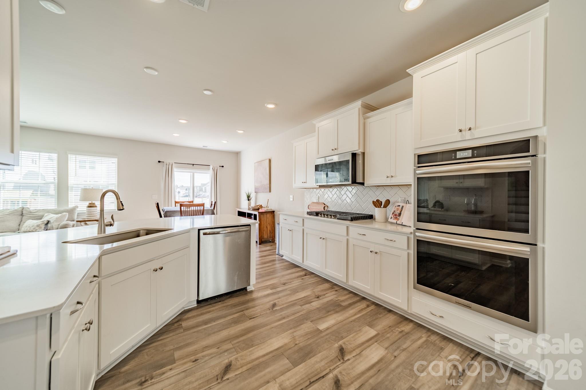 5542 Soft Shell Drive Lancaster, SC 29720 - Photo 7 of 43 a kitchen with sink a microwave and cabinets