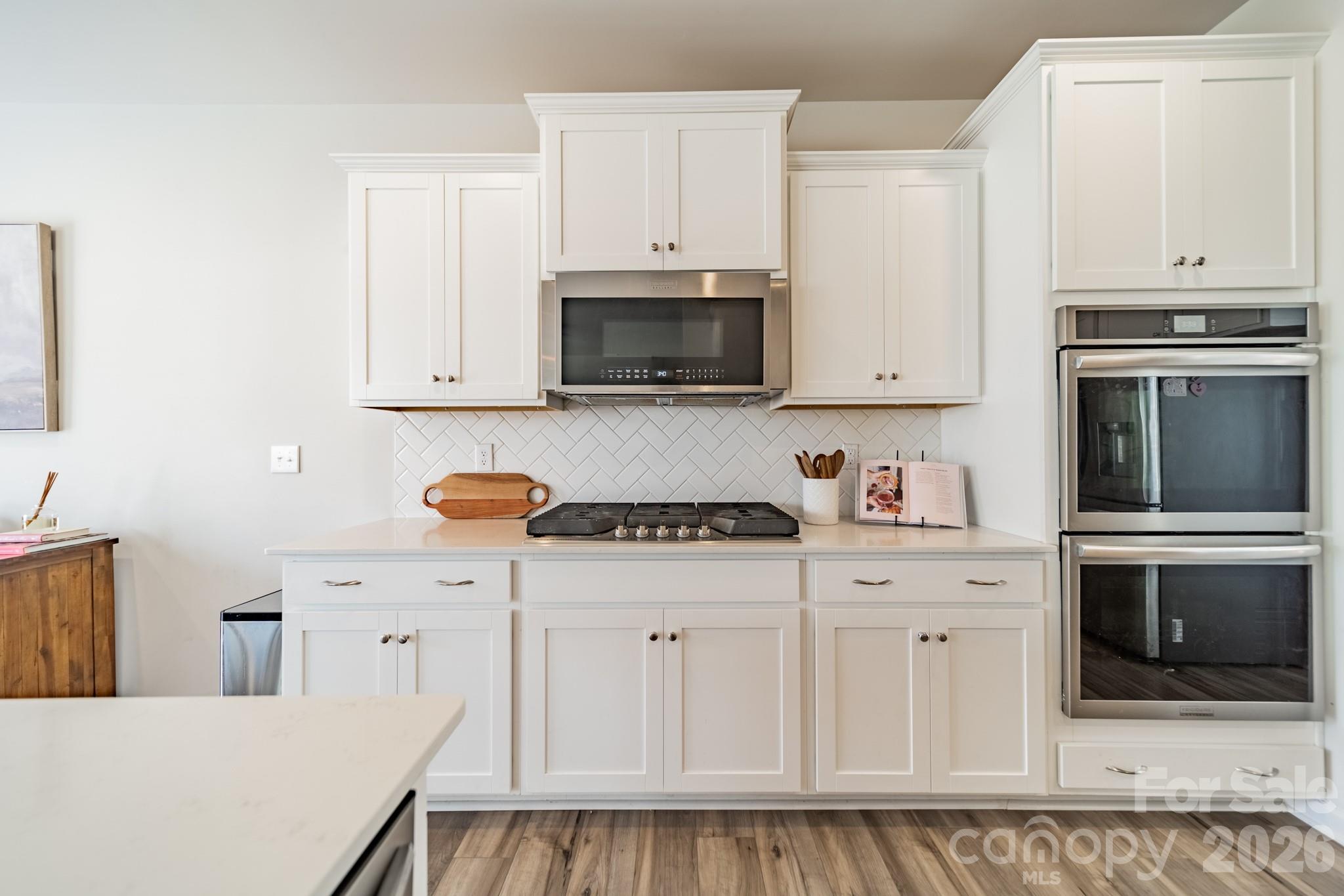 5542 Soft Shell Drive Lancaster, SC 29720 - Photo 8 of 43 a kitchen with white cabinets and stainless steel appliances