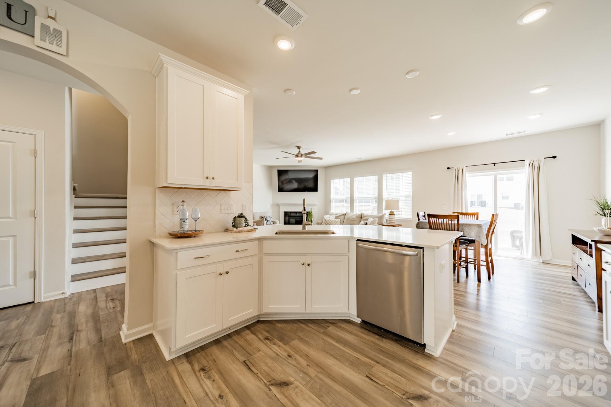 5542 Soft Shell Drive Lancaster, SC 29720 - Photo 9 of 43 a kitchen with white cabinets and wooden floor