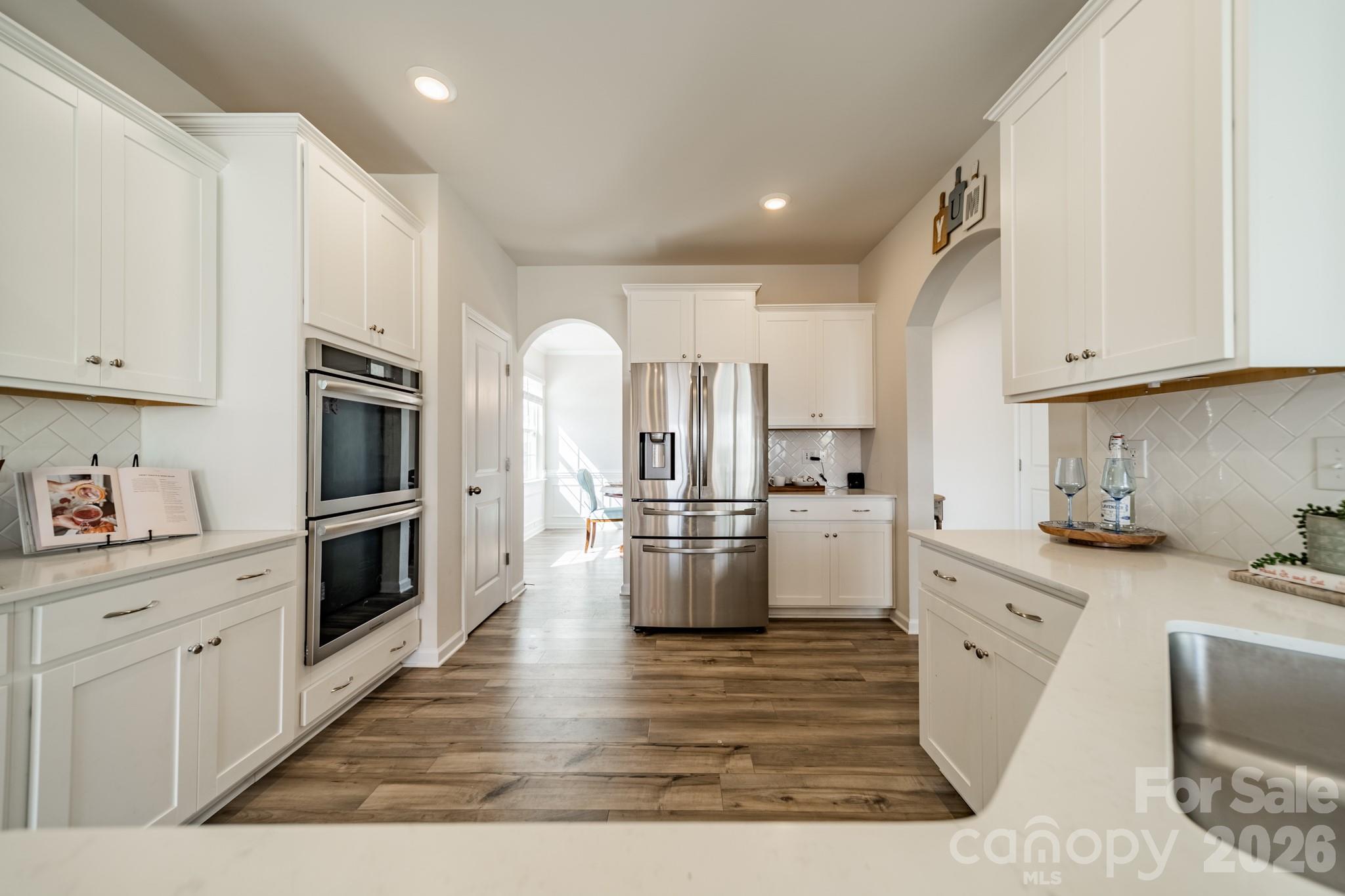 5542 Soft Shell Drive Lancaster, SC 29720 - Photo 10 of 43 a kitchen with white cabinets and stainless steel appliances