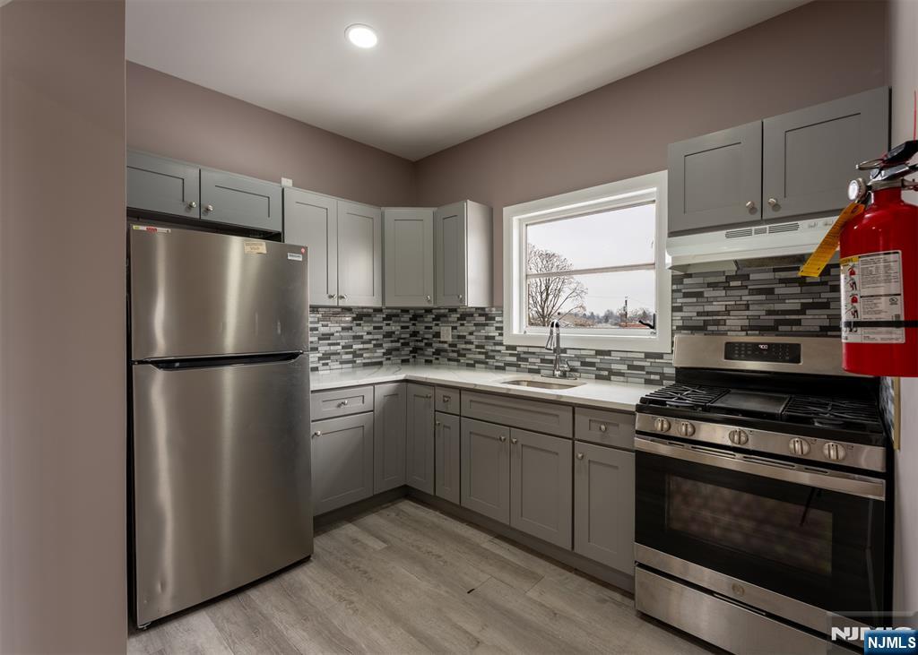 86 Hunter Street Lodi, NJ 07644 - Photo 1 of 18 a kitchen with stainless steel appliances a refrigerator sink and microwave