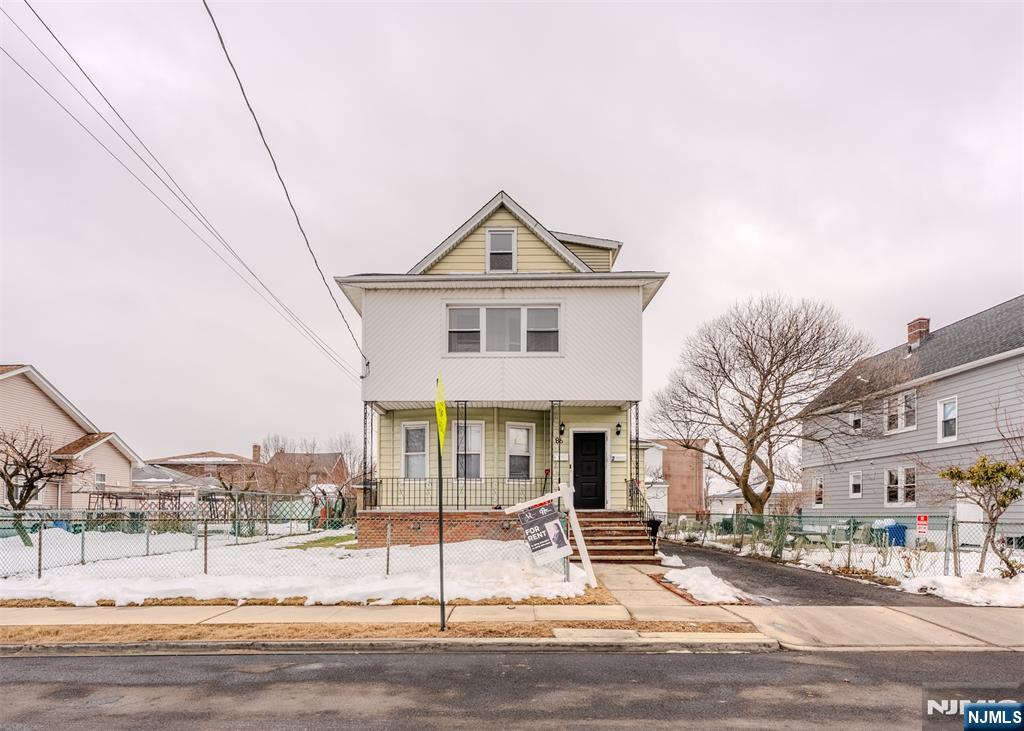 86 Hunter Street Lodi, NJ 07644 - Photo 16 of 18 a front view of a house with a yard