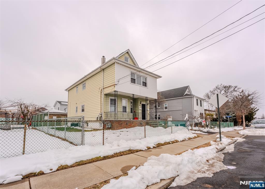 86 Hunter Street Lodi, NJ 07644 - Photo 17 of 18 a front view of a house with a yard