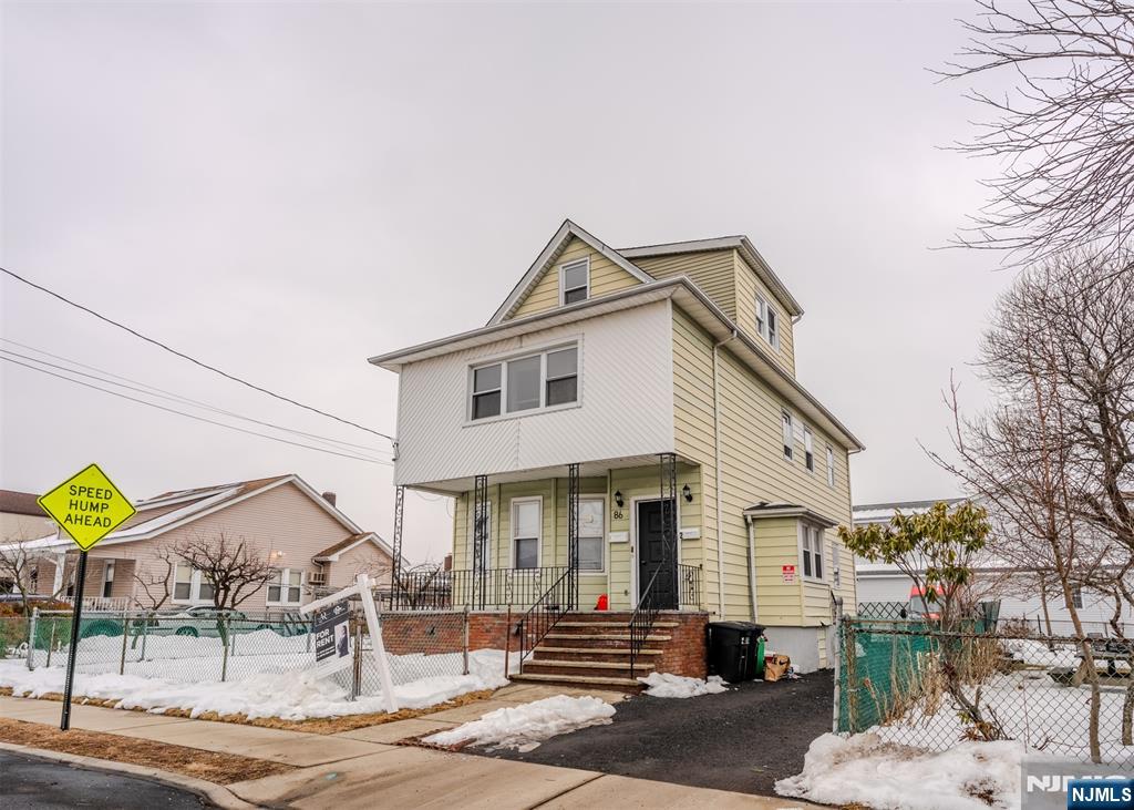 86 Hunter Street Lodi, NJ 07644 - Photo 18 of 18 a front view of a house with a garden and plants