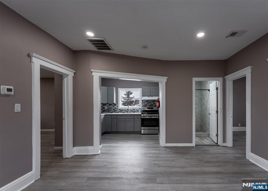 86 Hunter Street Lodi, NJ 07644 - Photo 5 of 18 a open kitchen with a sink and dishwasher a refrigerator with wooden floor