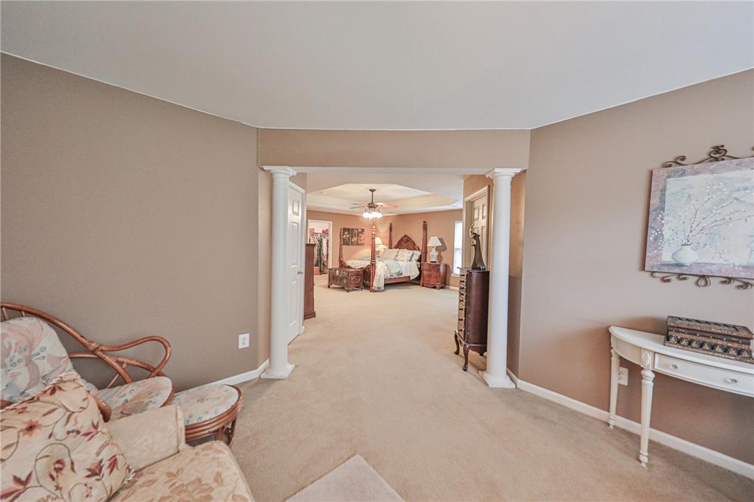 138 Clover Hollow Road Easton, PA 18045 - Photo 38 of 95 An inviting primary bedroom offers a tray ceiling and plush carpeting, creating a tranquil retreat.