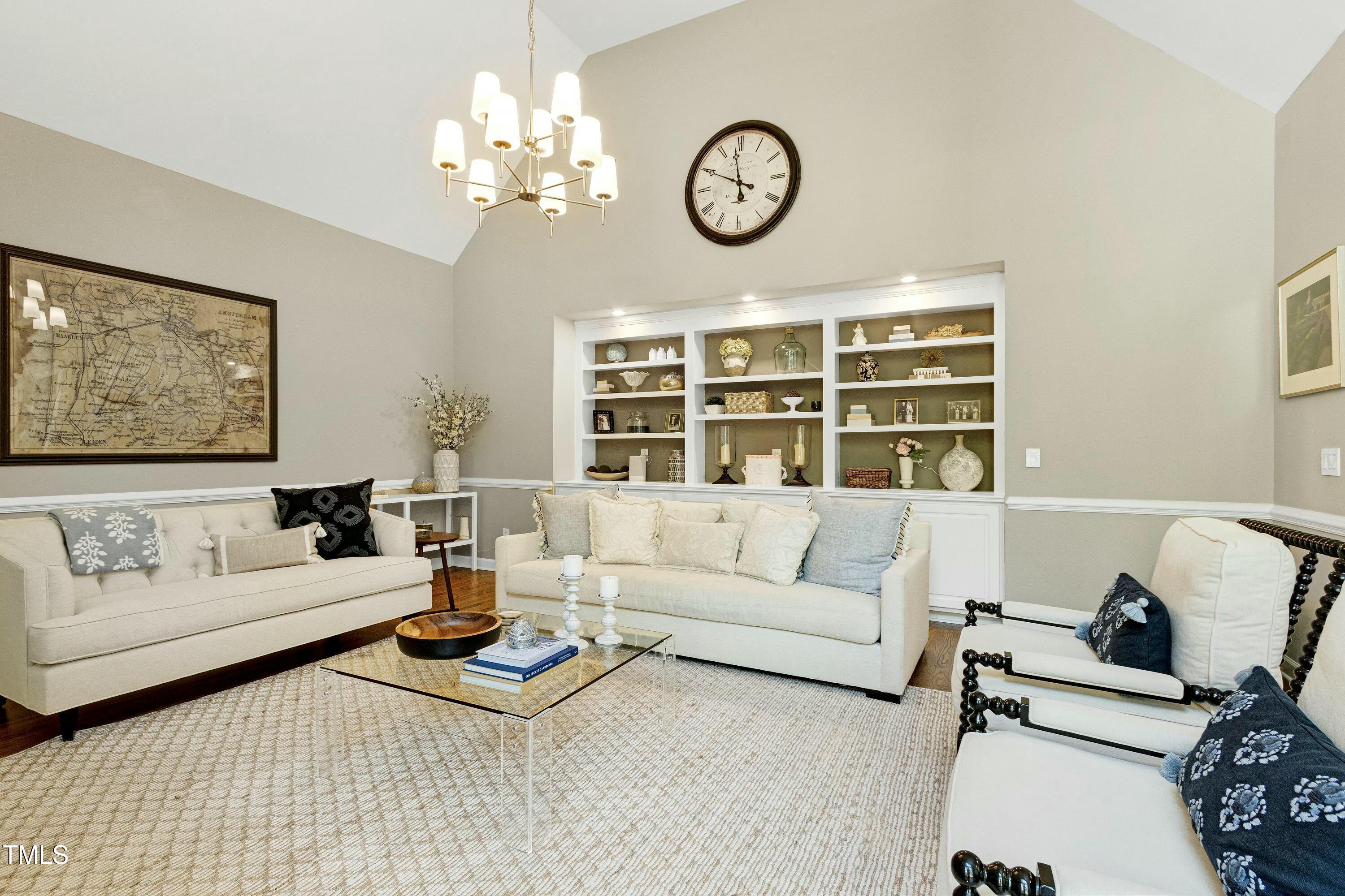 111 Finnway Lane Cary, NC 27519 - Photo 14 of 68 a living room with furniture a chandelier and a window