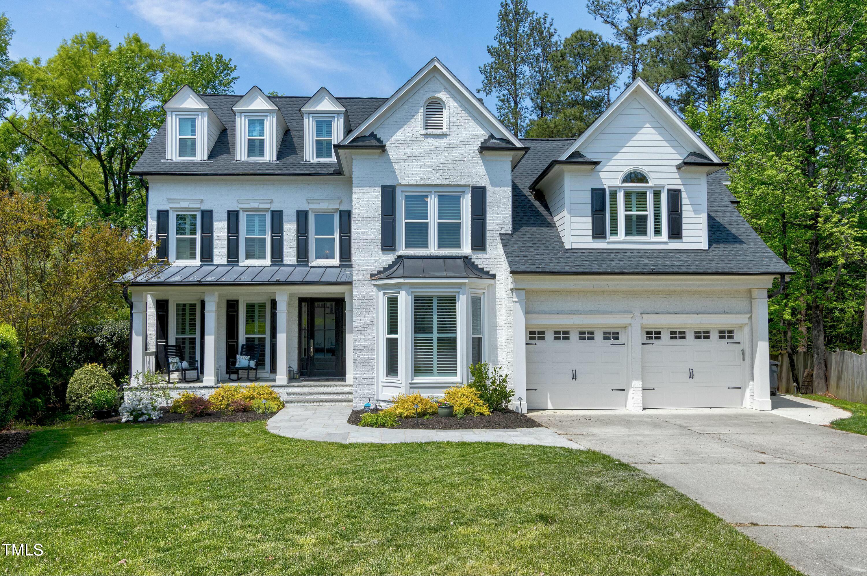 111 Finnway Lane Cary, NC 27519 - Photo 2 of 68 a front view of a house with glass windows and yard