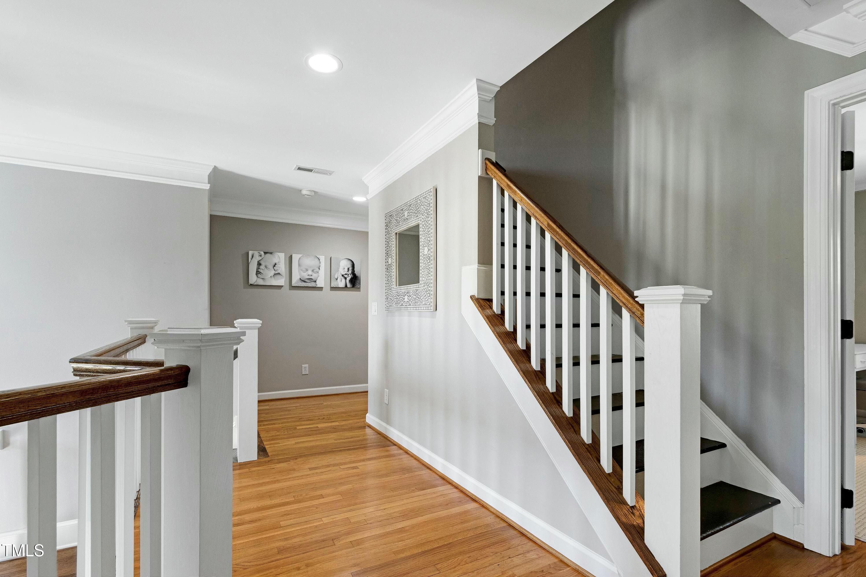 111 Finnway Lane Cary, NC 27519 - Photo 27 of 68 a view of a hallway with wooden floor and staircase