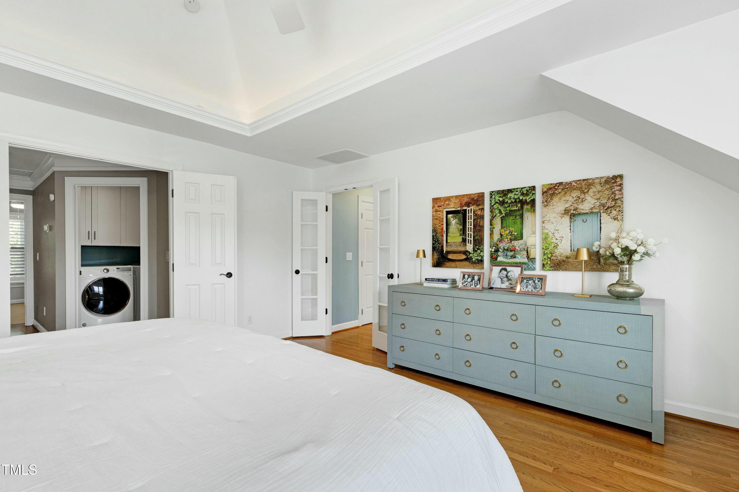 111 Finnway Lane Cary, NC 27519 - Photo 30 of 68 a bedroom with a bed and a large mirror on dresser