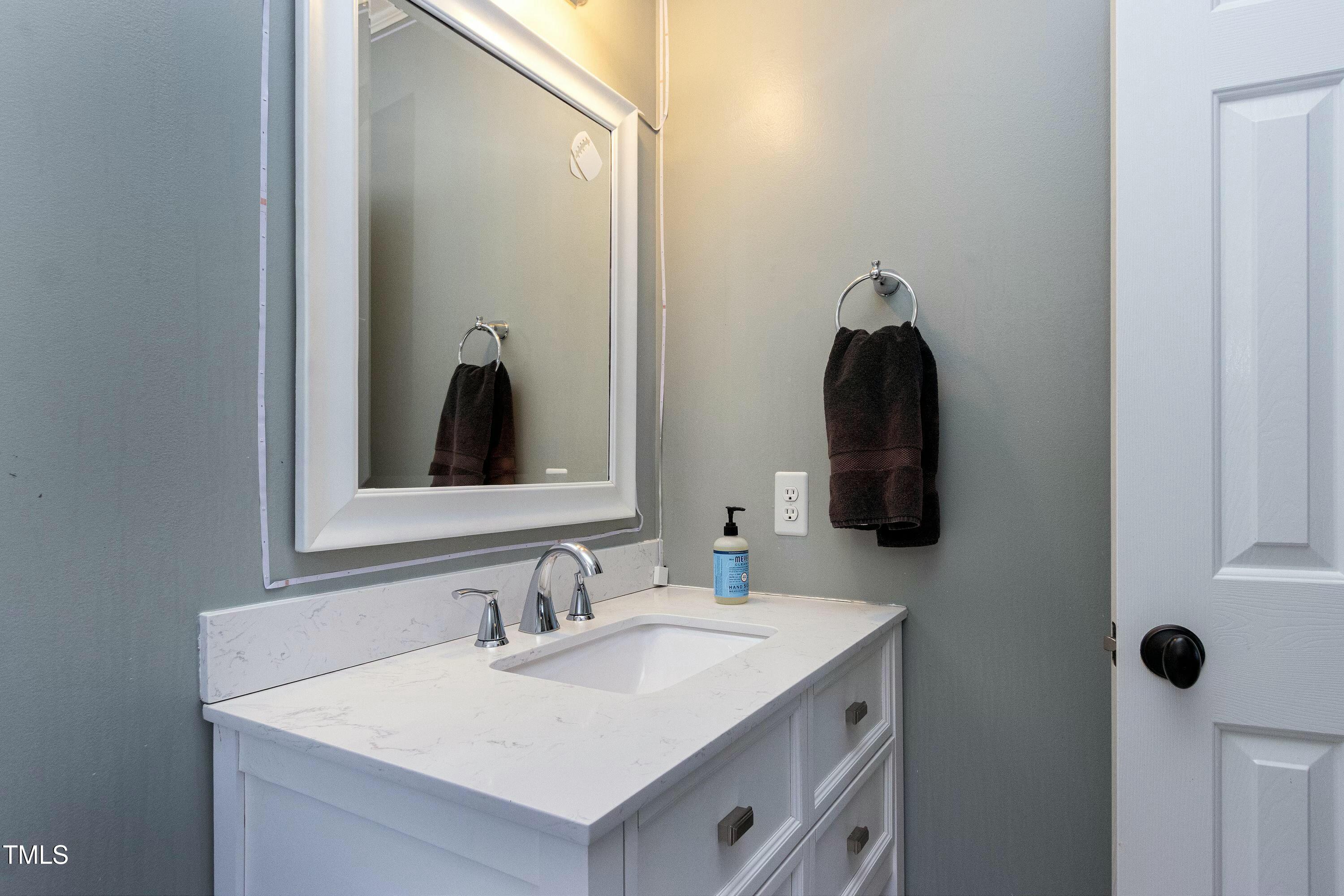 111 Finnway Lane Cary, NC 27519 - Photo 38 of 68 a bathroom with a sink and a mirror