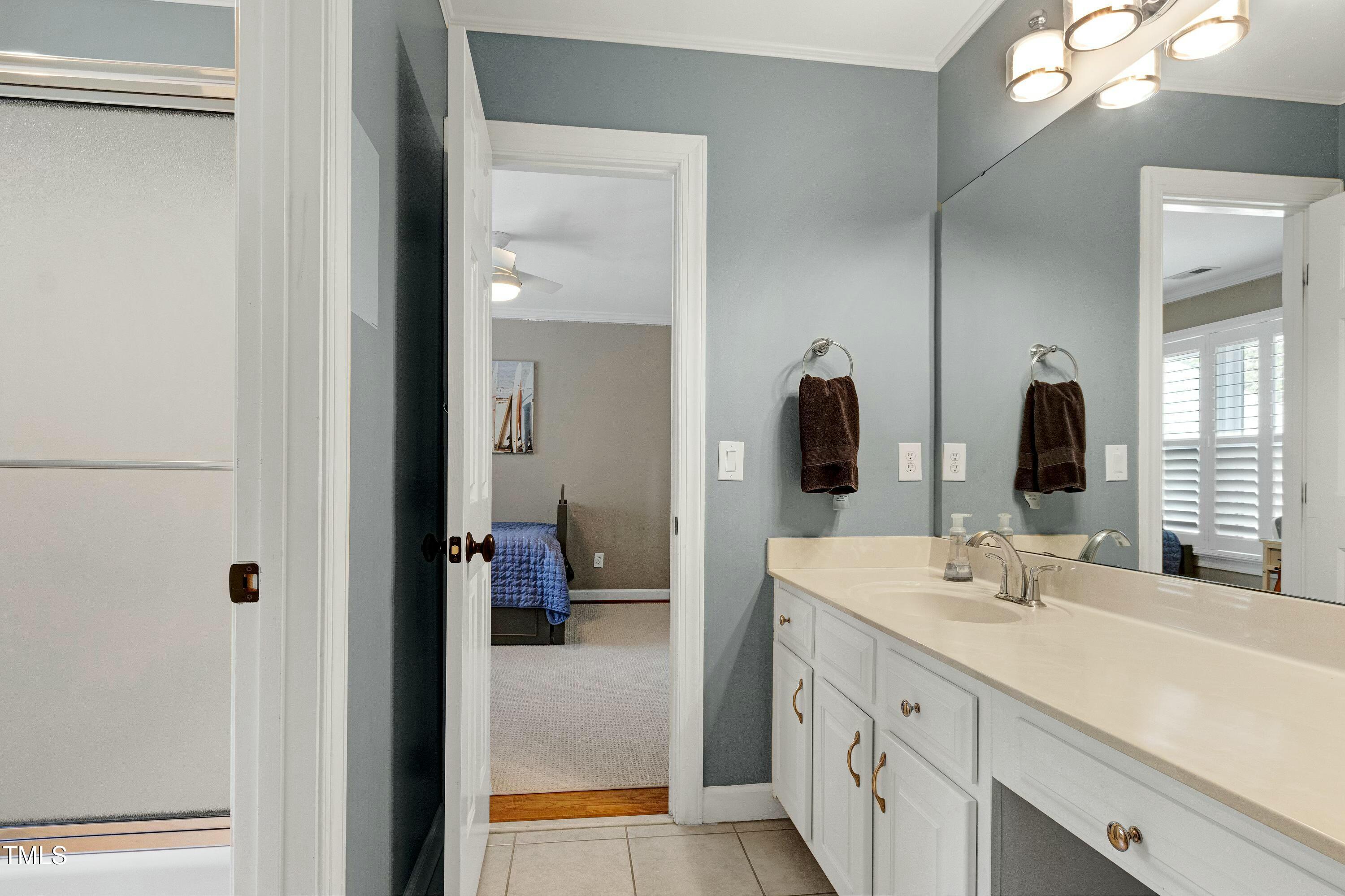 111 Finnway Lane Cary, NC 27519 - Photo 42 of 68 a en suite bathroom with a double vanity sink and a mirror