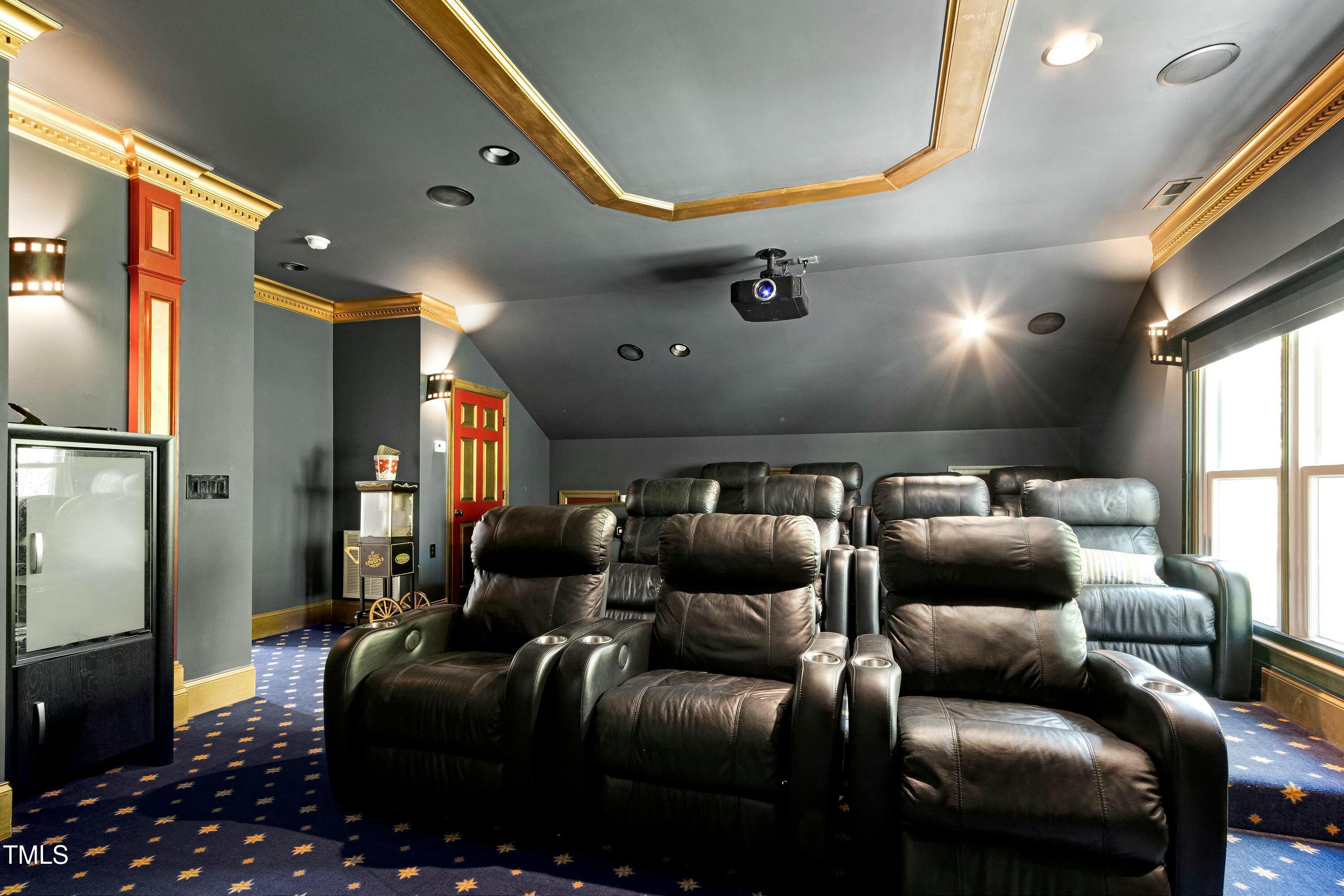 111 Finnway Lane Cary, NC 27519 - Photo 45 of 68 a media room with lots of chairs and a projector