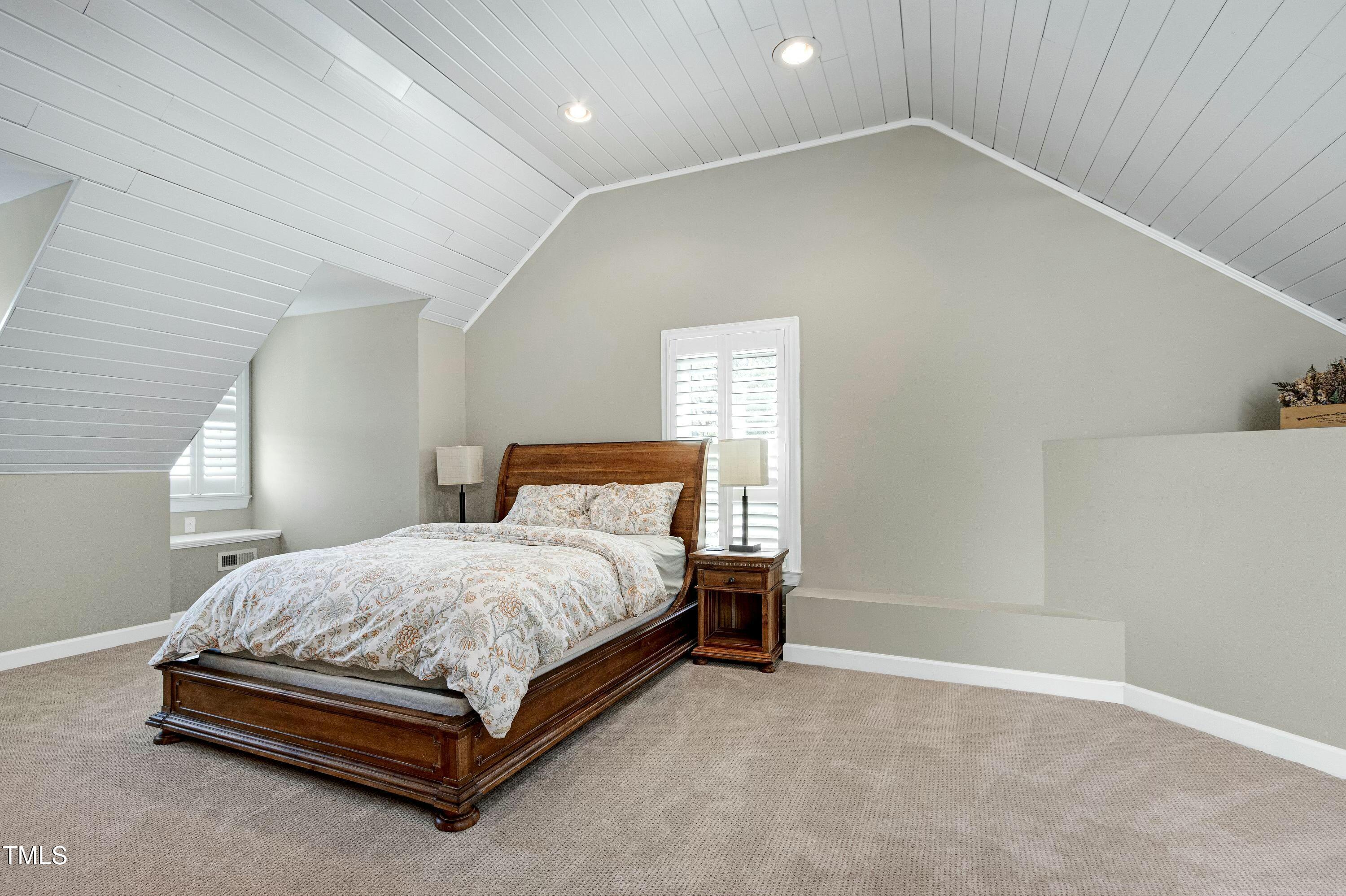 111 Finnway Lane Cary, NC 27519 - Photo 48 of 68 a bedroom with a bed and a lamp