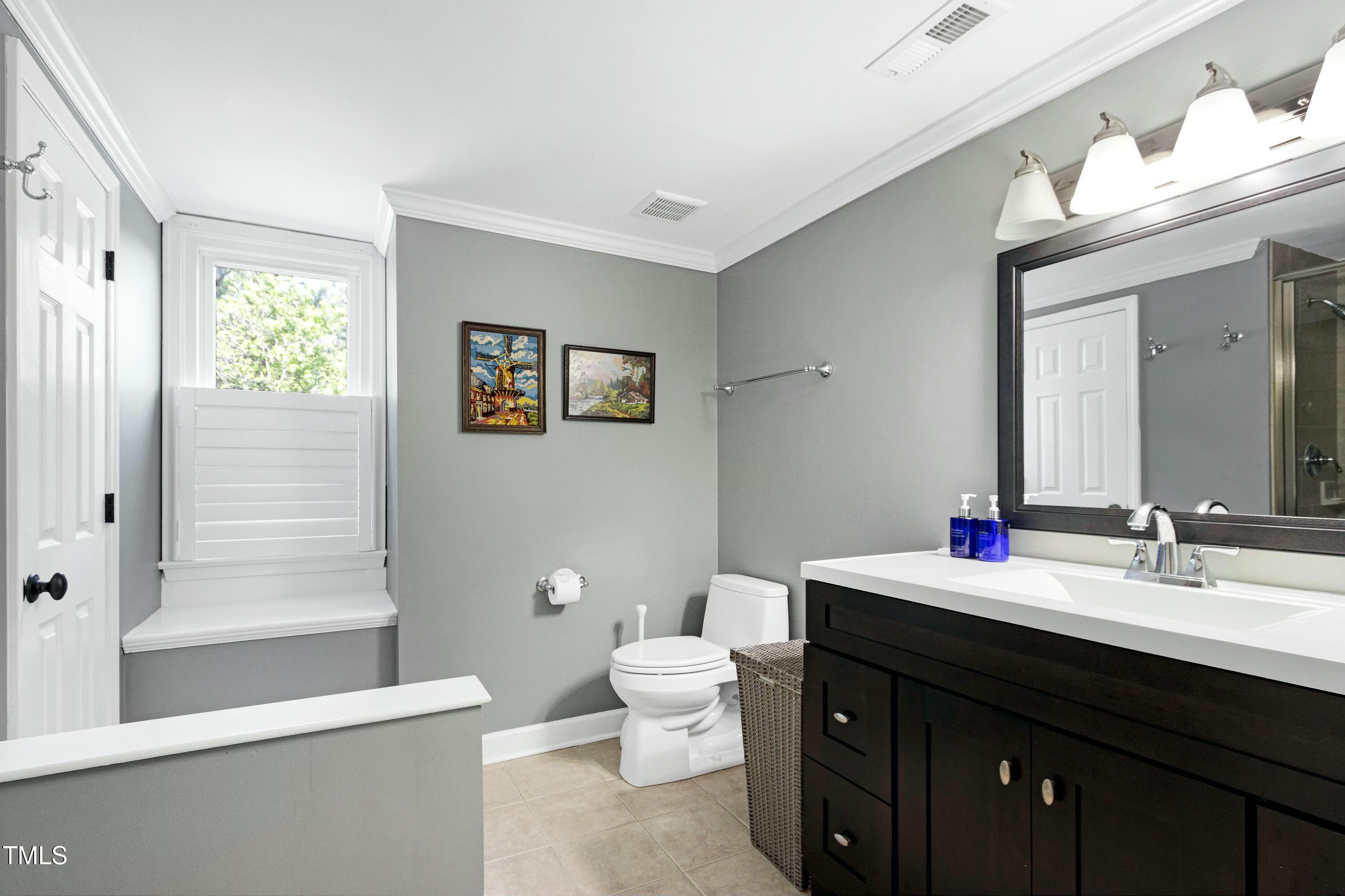 111 Finnway Lane Cary, NC 27519 - Photo 50 of 68 a bathroom with a double vanity sink toilet and a mirror