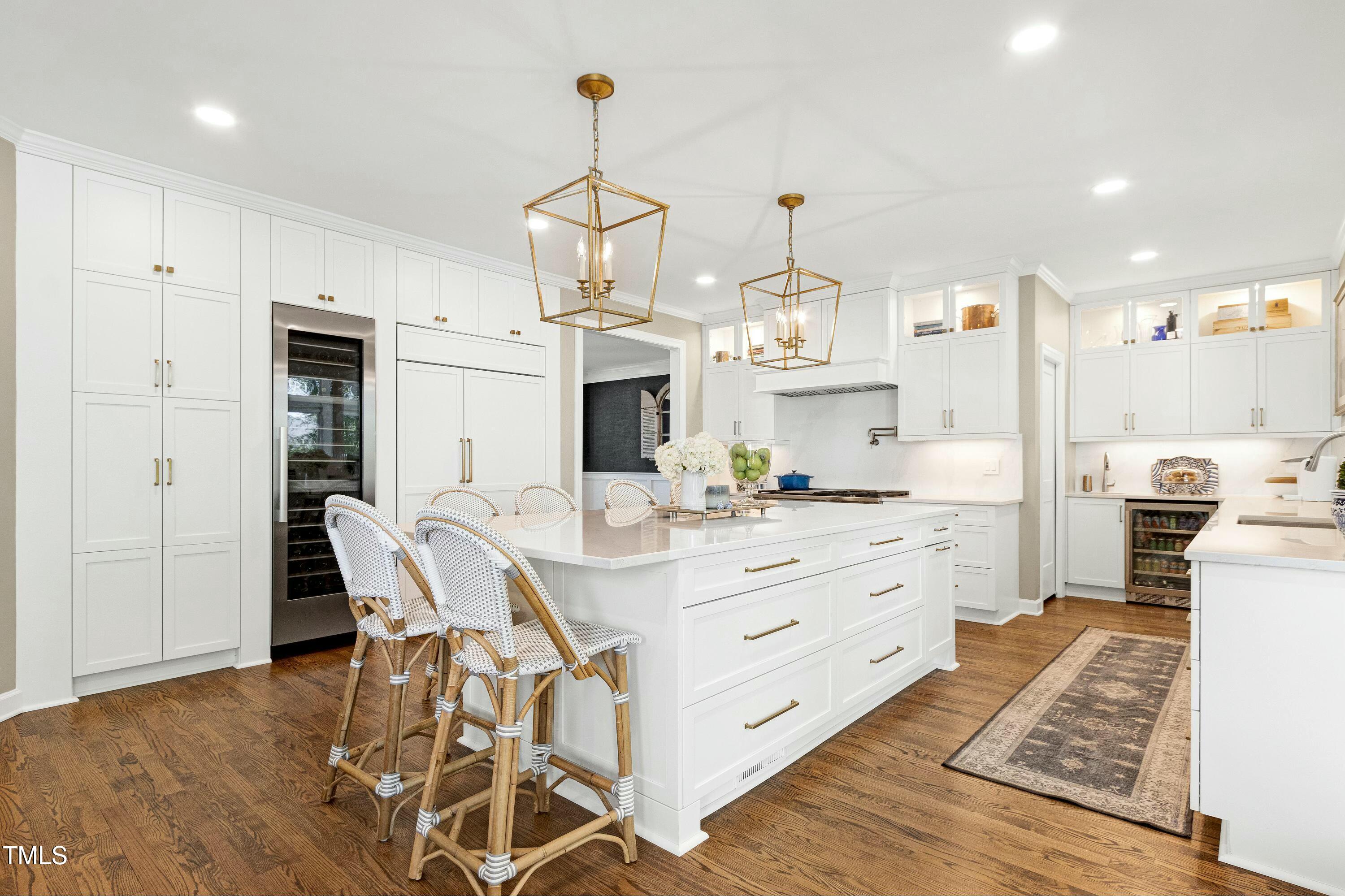 111 Finnway Lane Cary, NC 27519 - Photo 5 of 68 a large kitchen with kitchen island a chandelier and a view of living room