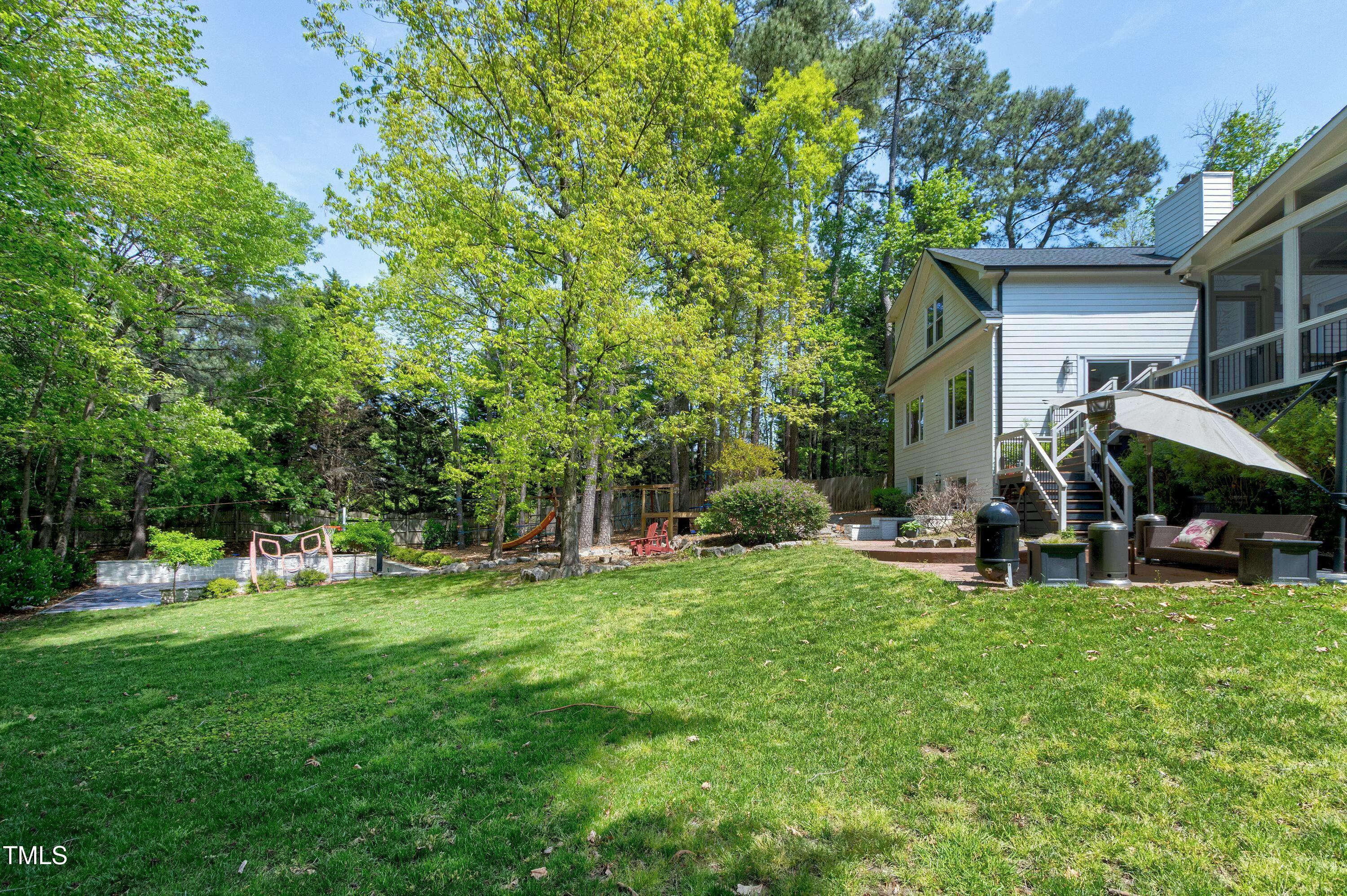 111 Finnway Lane Cary, NC 27519 - Photo 58 of 68 a view of a backyard with a sitting area and slide