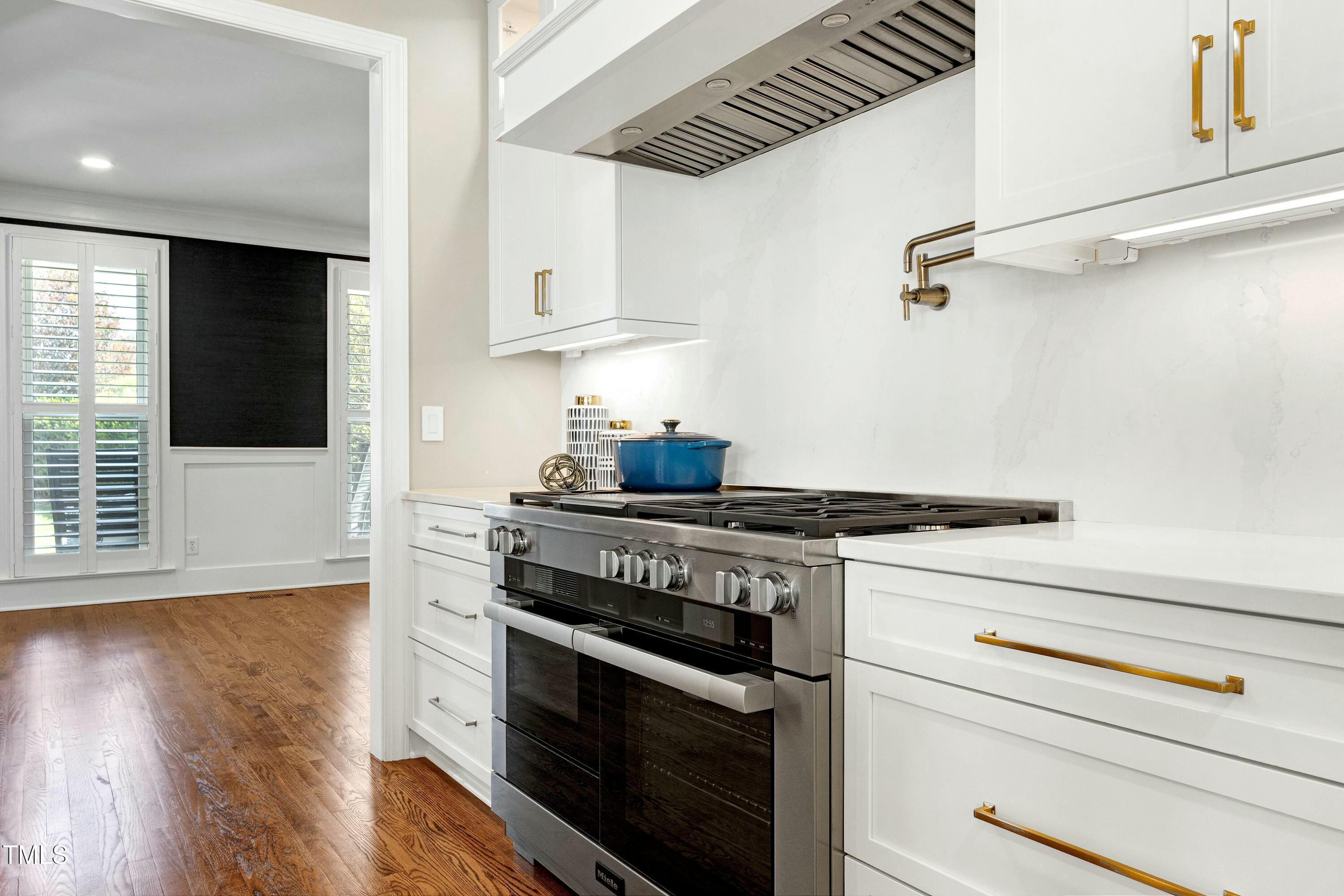 111 Finnway Lane Cary, NC 27519 - Photo 8 of 68 a kitchen with stainless steel appliances granite countertop a stove and a wooden floor
