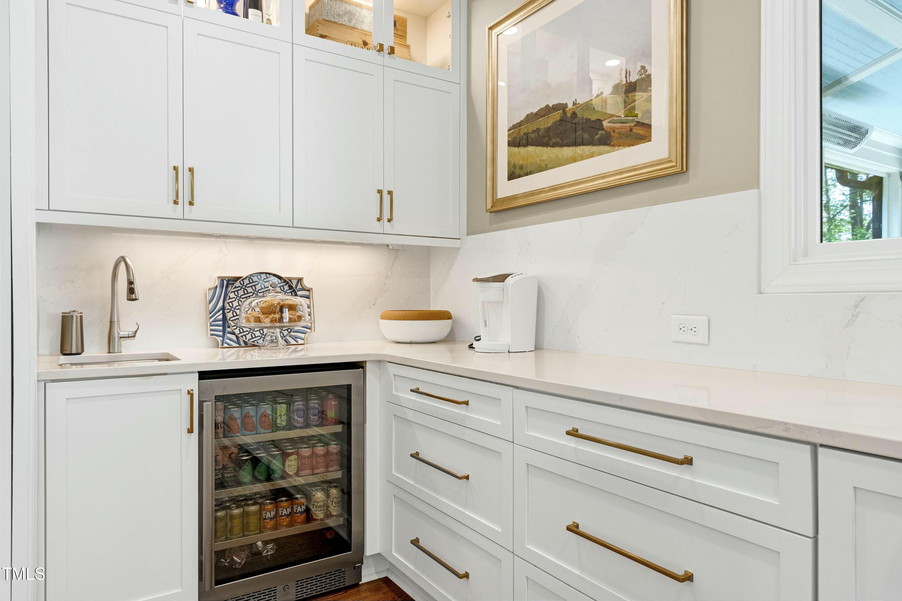 111 Finnway Lane Cary, NC 27519 - Photo 10 of 68 a kitchen with white cabinets and a wooden floor