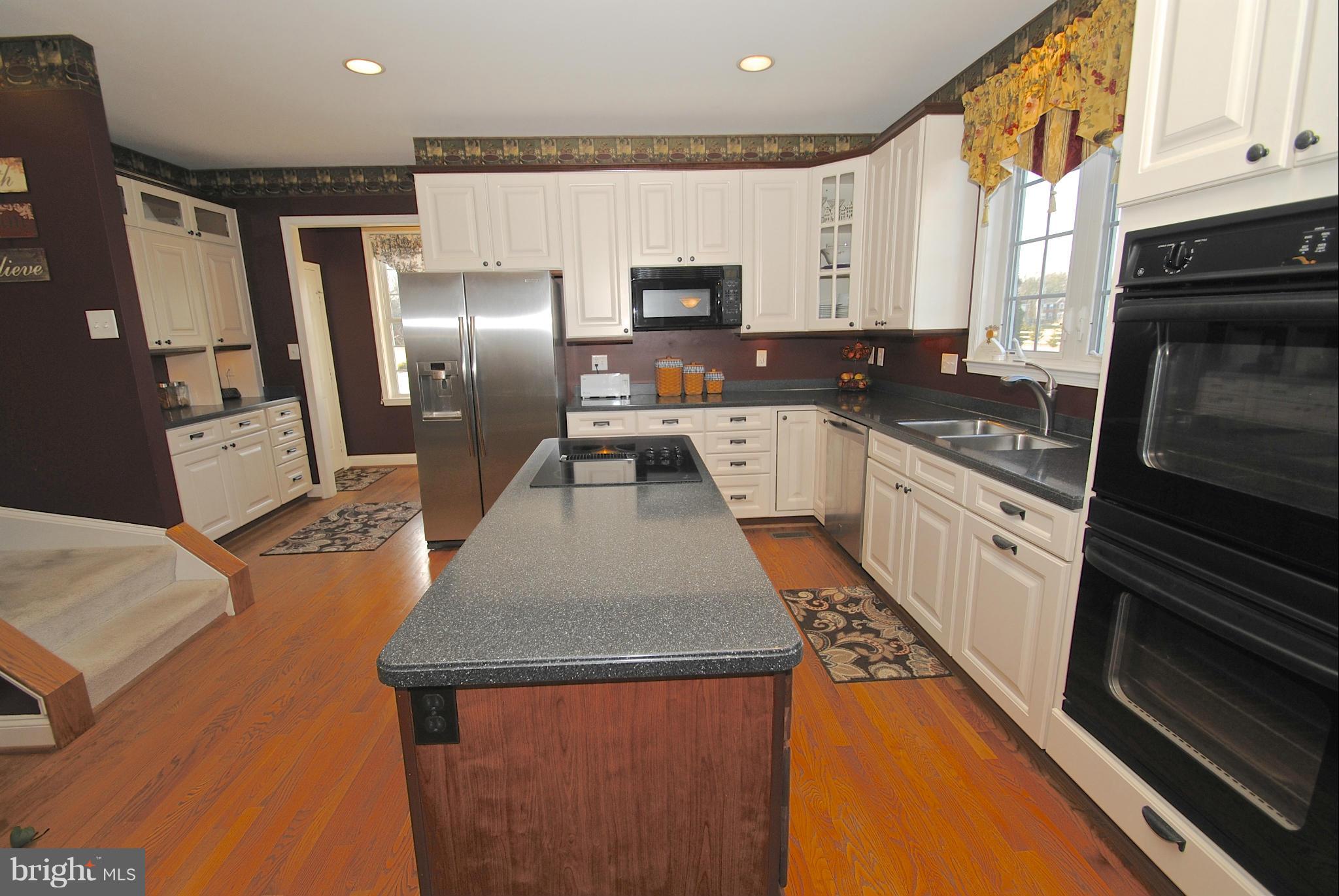6120 Scaggs Road Owings, MD 20736 - Photo 3 of 29 a kitchen with stainless steel appliances granite countertop a refrigerator stove microwave and sink