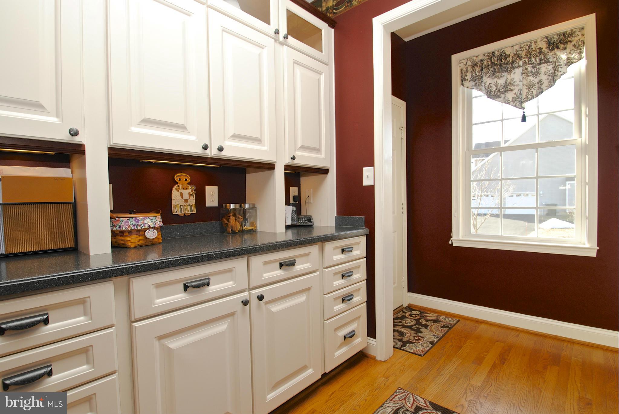6120 Scaggs Road Owings, MD 20736 - Photo 5 of 29 a kitchen with white cabinets and a window
