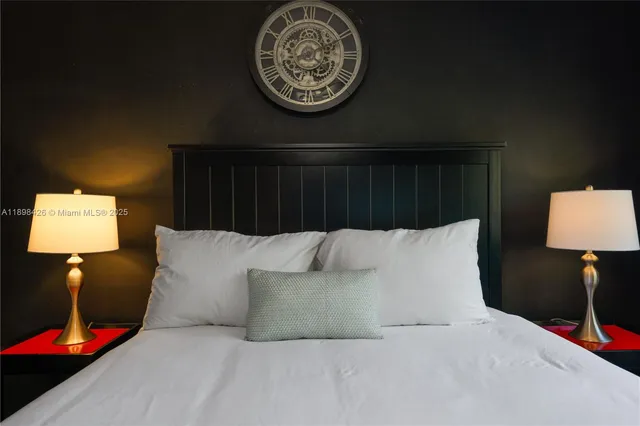 a bed sitting in a bedroom next to a lamp