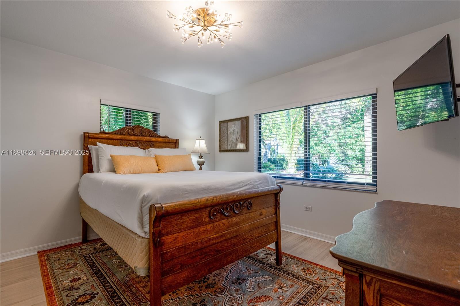29880 Southwest 183rd Court Homestead, FL 33030 - Photo 18 of 36 a bedroom with a bed and a window