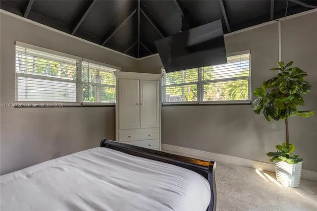 a bedroom with a bed and a potted plant
