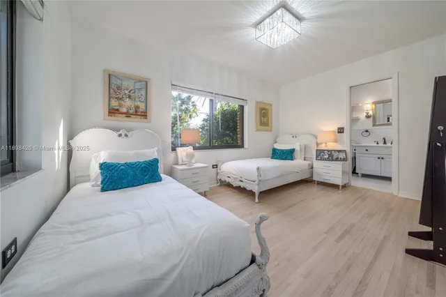 a bedroom with a bed and a large mirror