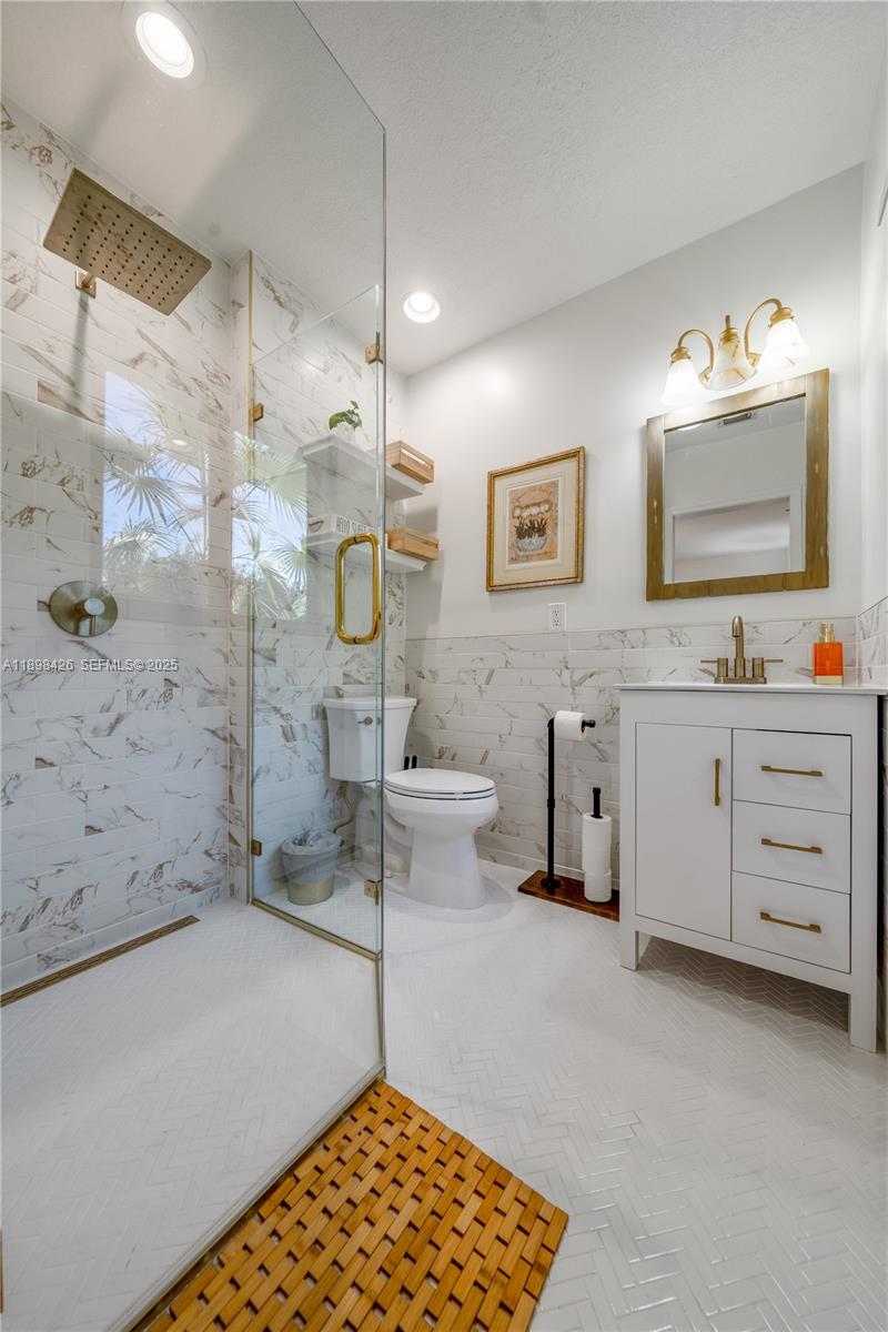 29880 Southwest 183rd Court Homestead, FL 33030 - Photo 24 of 36 a bathroom with a sink a toilet and shower