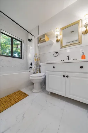 a bathroom with a sink a toilet and mirror