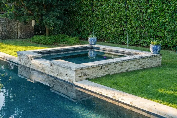 a view of a swimming pool with a yard
