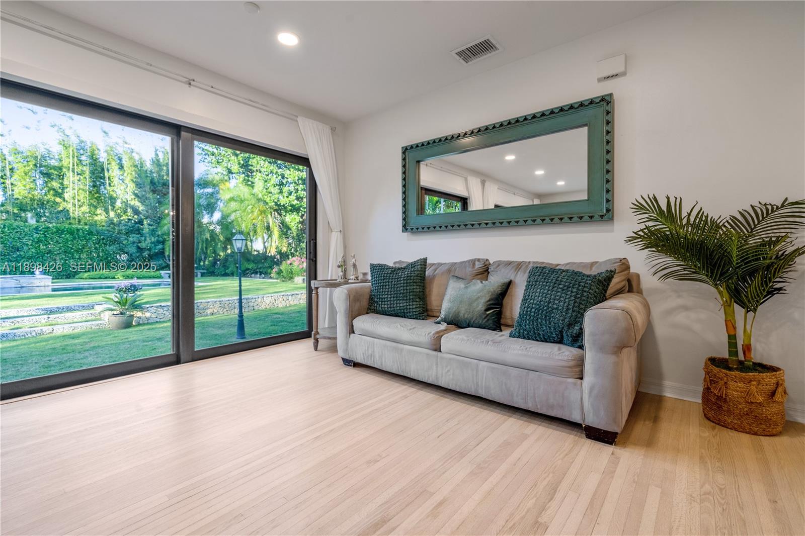 29880 Southwest 183rd Court Homestead, FL 33030 - Photo 7 of 36 a living room with furniture and a flat screen tv