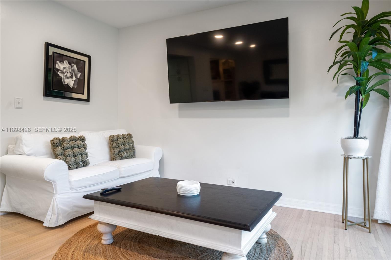 29880 Southwest 183rd Court Homestead, FL 33030 - Photo 8 of 36 a living room with furniture and a flat screen tv