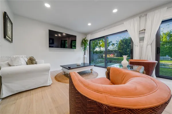 a projector room with furniture and a flat screen tv