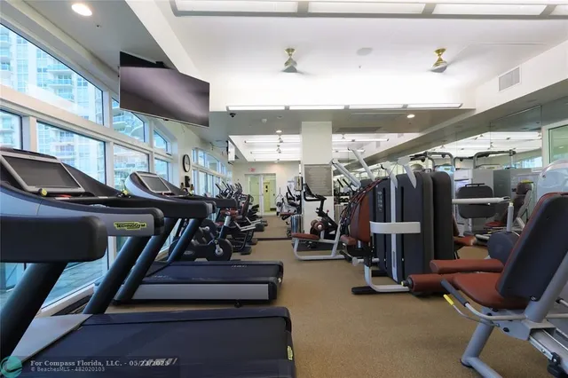 a living room with furniture and a pool table