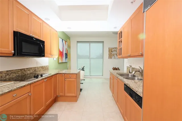 a kitchen with stainless steel appliances granite countertop a sink stove and microwave