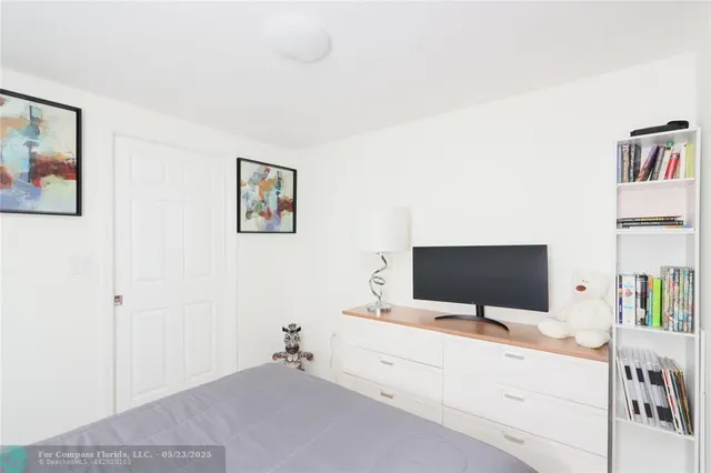 a bedroom with a bed and a flat screen tv