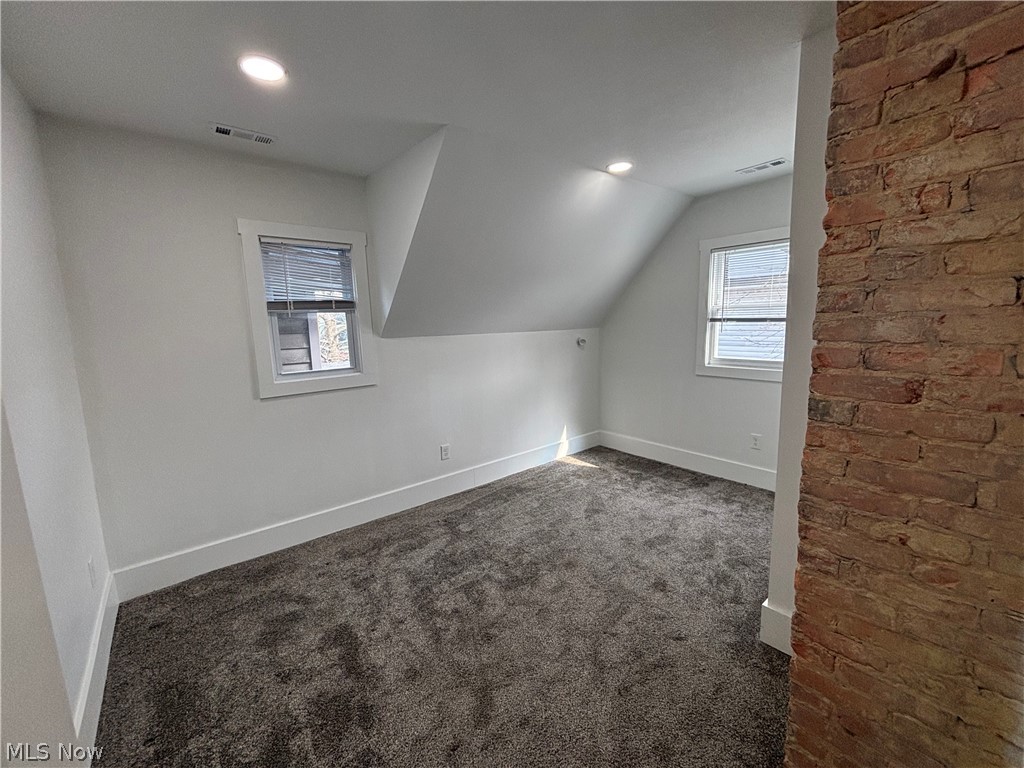4115 Whitman Avenue, Unit UP Cleveland, OH 44113 - Photo 9 of 12 Bonus room featuring dark carpet, recessed lighting, and vaulted ceiling