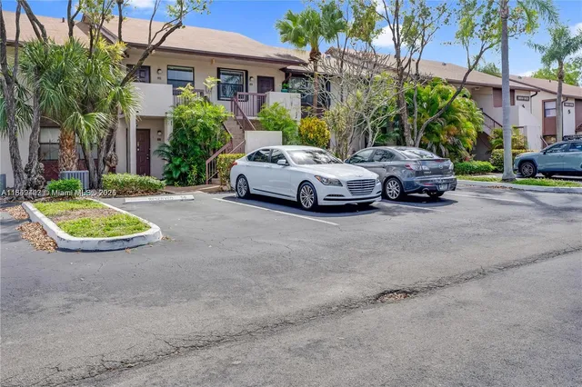 a view of a car parked in front of a brick house