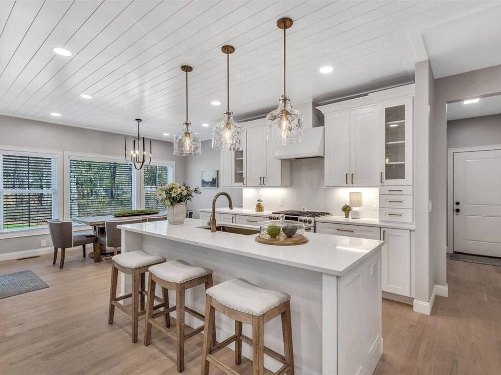 9 West Way Mashpee, MA 02649 - Photo 13 of 42 a kitchen with kitchen island a stove a table a sink refrigerator and cabinets