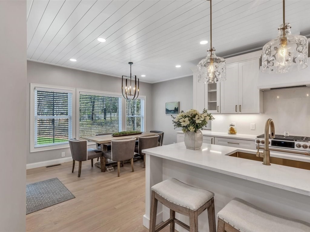 9 West Way Mashpee, MA 02649 - Photo 19 of 42 a dining room with wooden floor a chandelier a wooden table and chairs