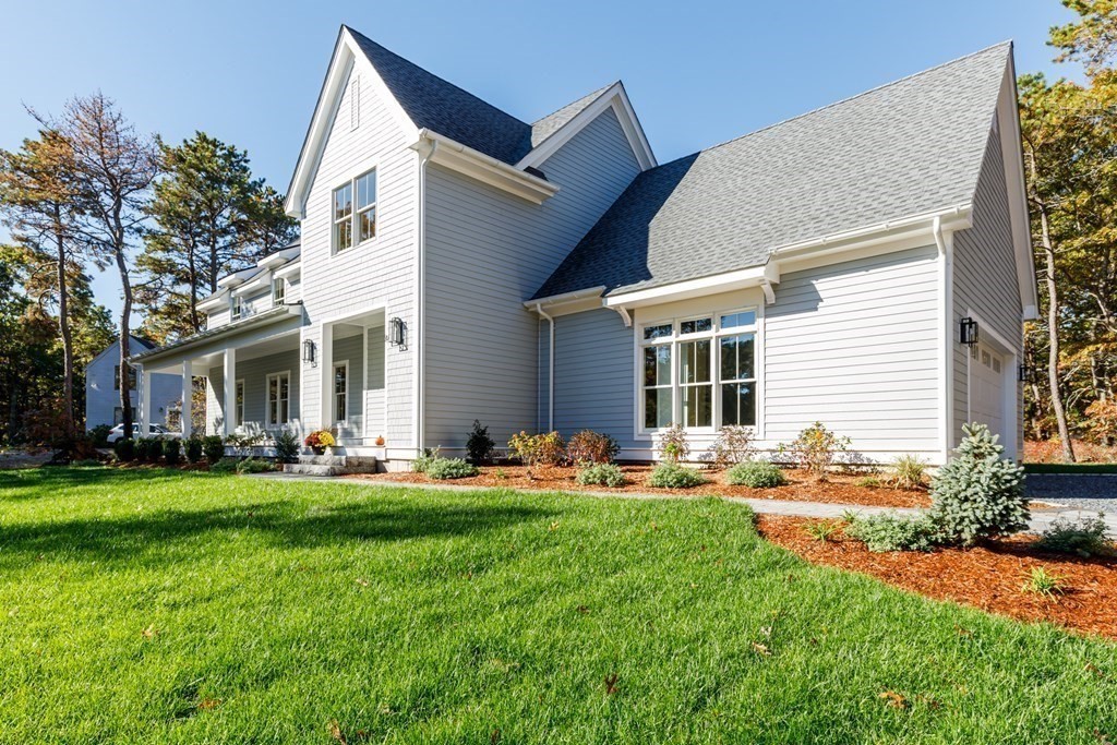 9 West Way Mashpee, MA 02649 - Photo 3 of 42 a backyard of a house with garden and outdoor seating