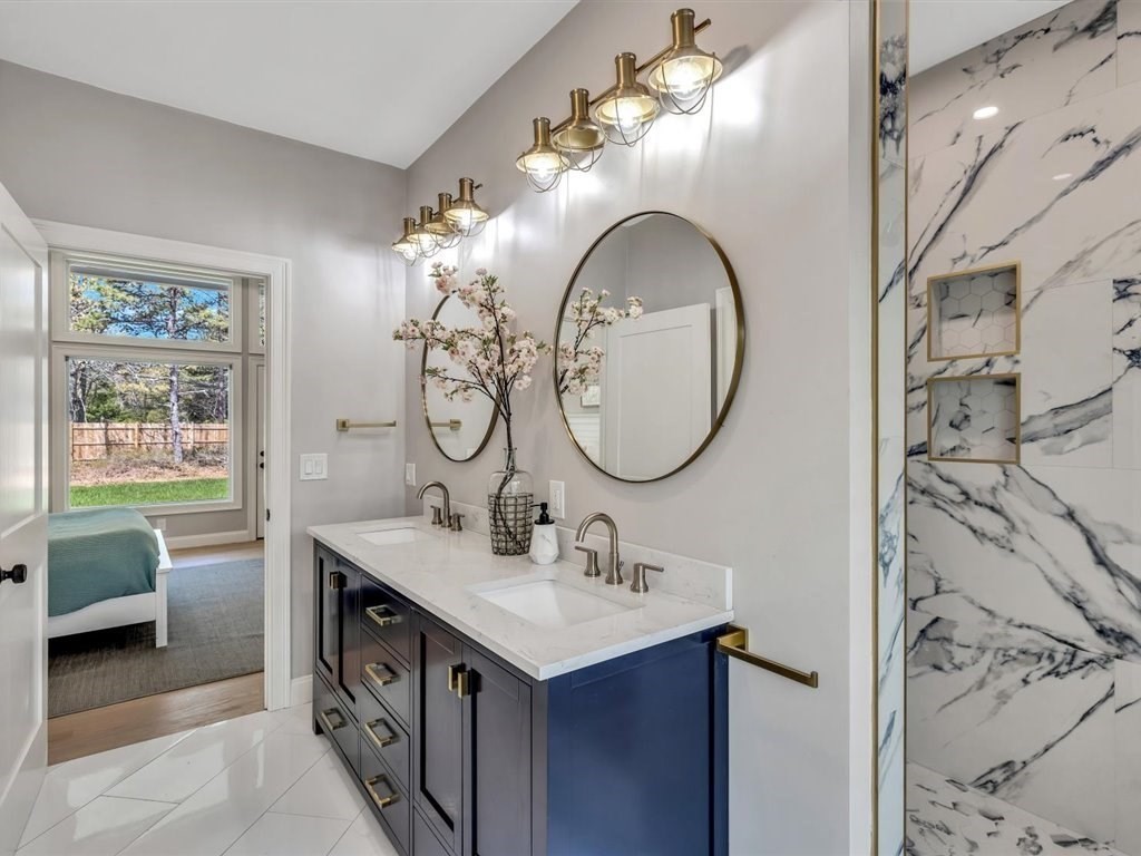 9 West Way Mashpee, MA 02649 - Photo 33 of 42 a bathroom with a double vanity sink a mirror and a bathtub