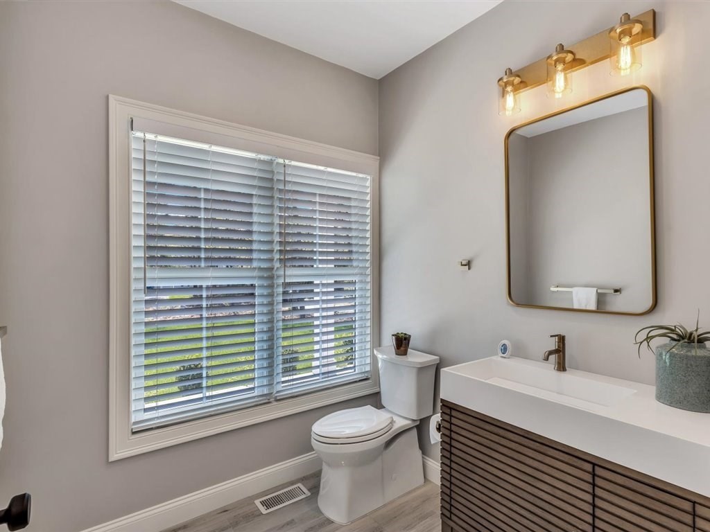 9 West Way Mashpee, MA 02649 - Photo 34 of 42 a bathroom with a granite countertop toilet a sink a mirror and a window