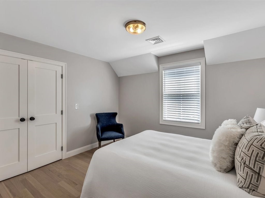 9 West Way Mashpee, MA 02649 - Photo 39 of 42 a bedroom with a bed and a lamp next to a window