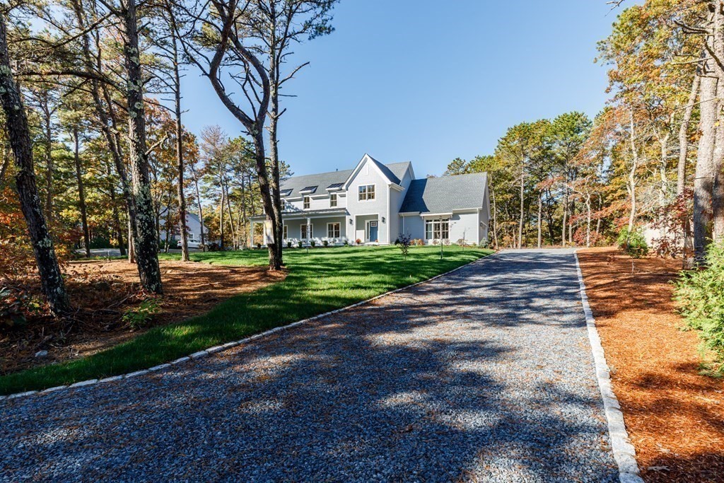9 West Way Mashpee, MA 02649 - Photo 4 of 42 a front view of a house with a yard and trees